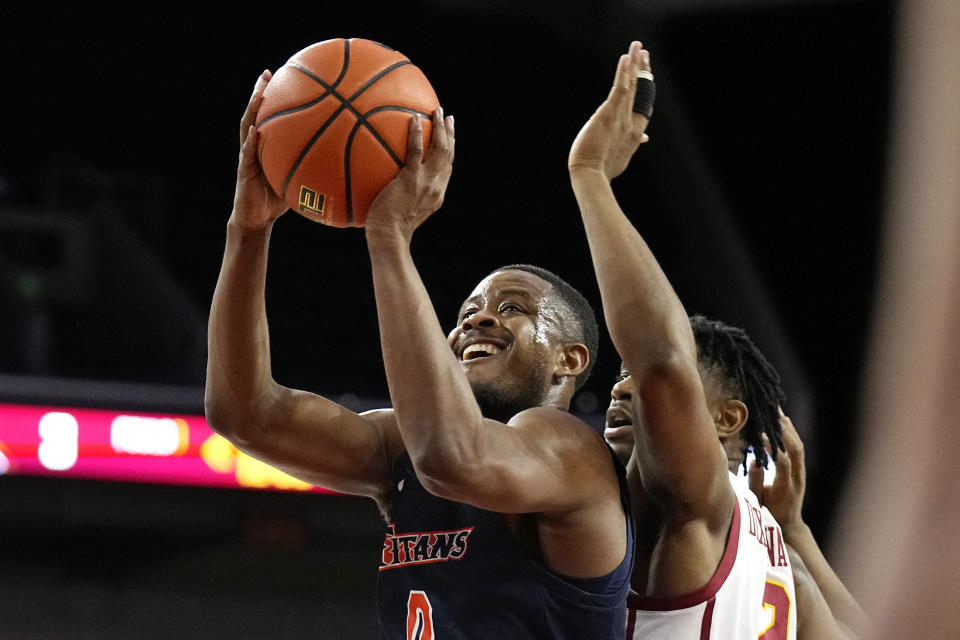 Cal State Fullerton guard Jalen Harris, left, shoots as Southern California guard Reese Dixon-Waters defends during the first half of an NCAA college basketball game Wednesday, Dec. 7, 2022, in Los Angeles. (AP Photo/Mark J. Terrill)