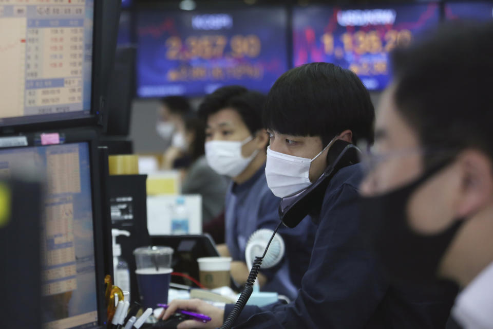 A currency trader talks on the phone at the foreign exchange dealing room of the KEB Hana Bank headquarters in Seoul, South Korea, Friday, Oct. 23, 2020. Shares were mostly higher in Asia on Friday after President Donald Trump and his challenger former Vice President Joe Biden faced off in their second and final debate before the Nov. 3 election. (AP Photo/Ahn Young-joon)