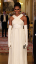 <p> Obama shone in a beautiful white dress by Tom Ford at Buckingham Palace ahead of a State Banquet in 2011. The short-sleeved gown featured a criss-cross neckline and white ribbon tie at the waist. She accessorised with long white gloves, an elegant updo, diamond earrings and a sparkly silver clutch. </p>
