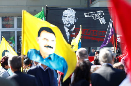 People hold banners and flags during a demonstration against Erdogan dictatorship and in favour of democracy in Turkey in Bern, Switzerland March 25, 2017. REUTERS/Ruben Sprich