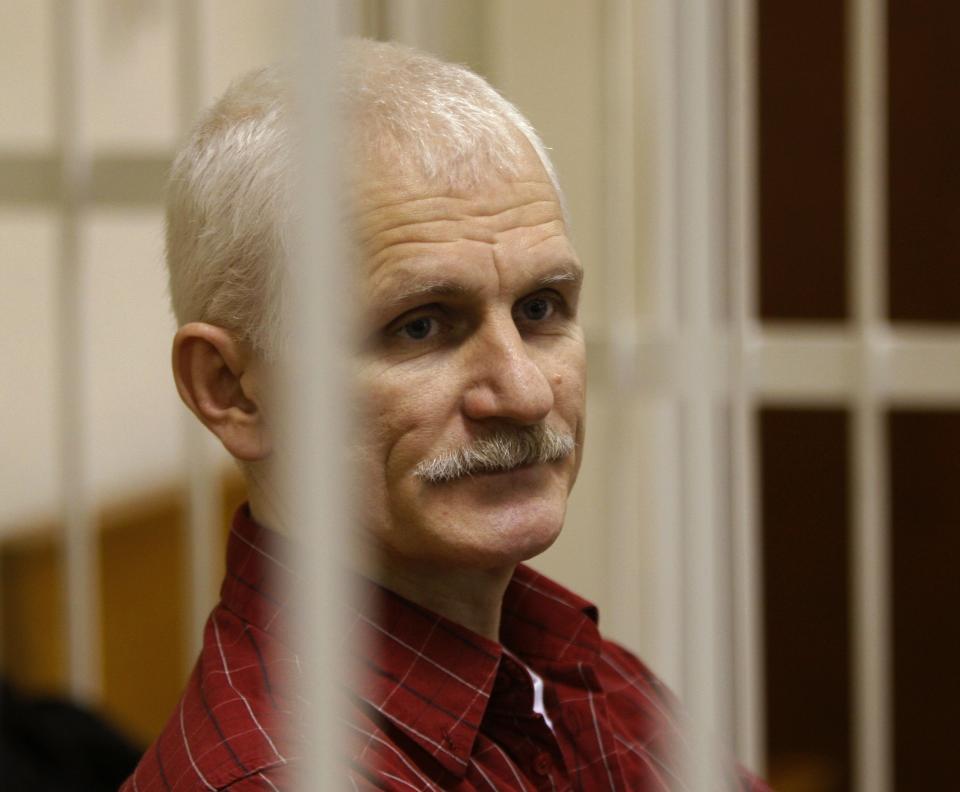 FILE - Ales Bialiatski, the head of Belarusian Viasna rights group, stands in a defendants' cage during a court session in Minsk, Belarus, on Nov. 2, 2011. Activist Ales Bialiatski, who shared the 2022 Nobel Peace Prize with human rights groups in Russia and Ukraine, is the fourth person in the 121-year history of the Nobel Prizes to receive the peace award while in prison or detention. (AP Photo/Sergei Grits, File)