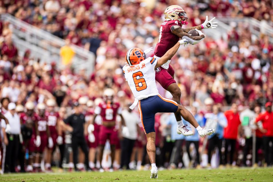 TALLAHASSEE, FLORIDA - OCTOBER 14: Keon Coleman #4 of the Florida State Seminoles catches a pass against Jason Simmons jr. #6 of the Syracuse Orange during the first half of a game at Doak Campbell Stadium on October 14, 2023 in Tallahassee, Florida. (Photo by James Gilbert/Getty Images)