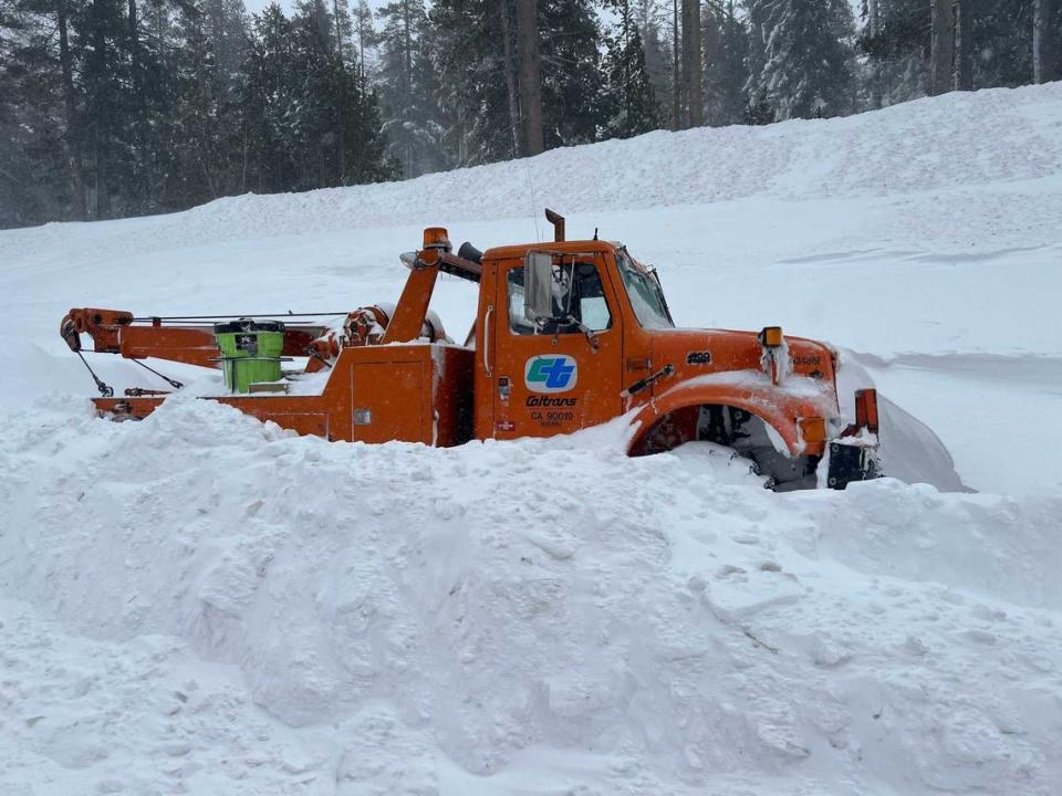 A Caltrans tow truck is surrounded by snow along a closed Interstate 80 near Donner Pass on Saturday, March 2, 2024, after authorities shut down the major freeway due to whiteout conditions. A blizzard that was raking over the Sierra is expected to dump as much as 12 feet of snow on the region by the end of Sunday.