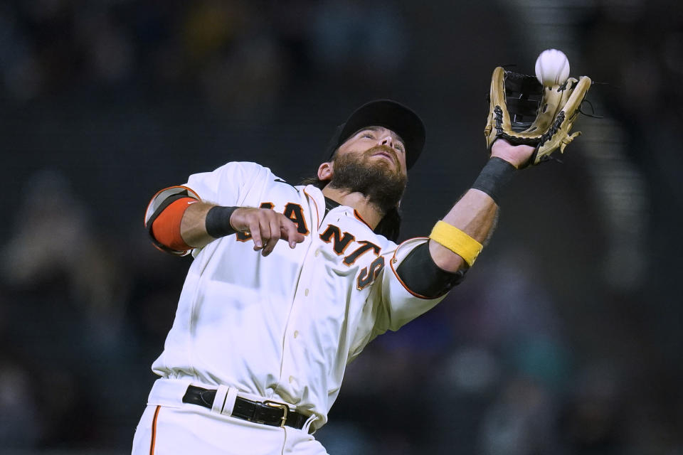 San Francisco Giants shortstop Brandon Crawford catches a popup by Colorado Rockies' Elehuris Montero during the fourth inning of a baseball game in San Francisco, Wednesday, Sept. 28, 2022. (AP Photo/Godofredo A. Vásquez)