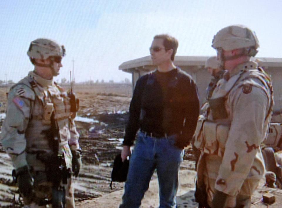 PHOTO: Bob Woodruff, center, talks with U.S. soldiers, Jan. 29, 2006 prior to him and his cameraman Doug Vogt being injured in a roadside bombing in Iraq. (ABC via AP)