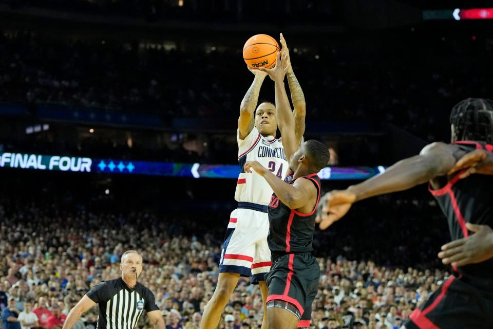 Connecticut guard Jordan Hawkins (24) shoots the ball against San Diego State guard Lamont Butler (5) during  the national championship game of the 2023 NCAA men's tournament at NRG Stadium.