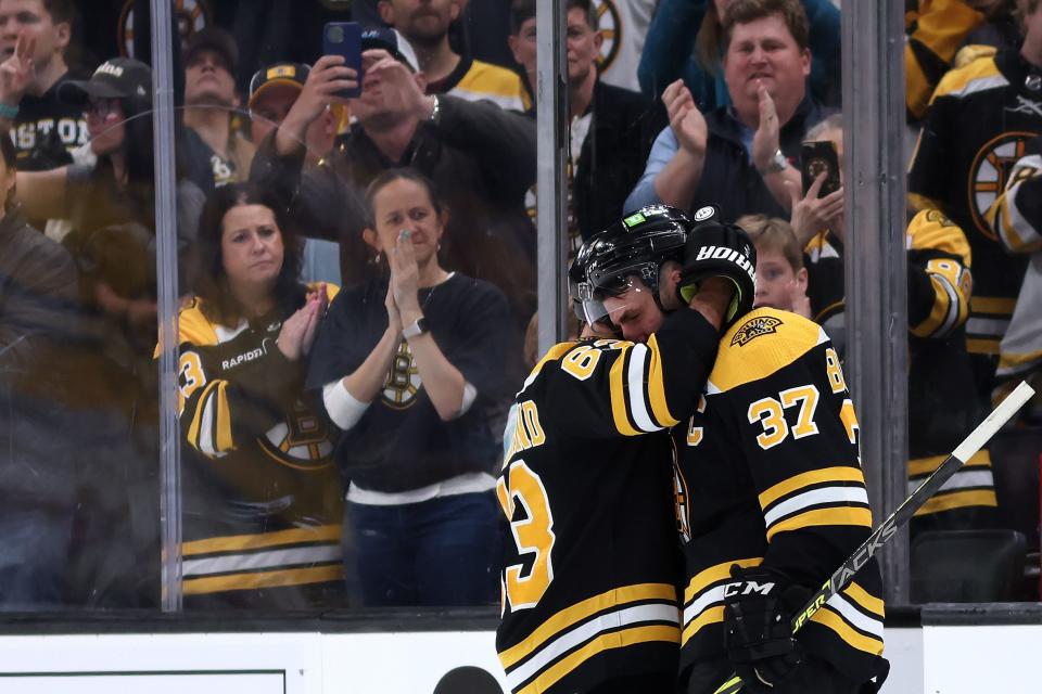 BOSTON, MASSACHUSETTS - APRIL 30: Patrice Bergeron #37 of the Boston Bruins hugs Brad Marchand #63 before exiting the ice after Florida Panthers defeat the Bruins 4-3 in overtime of Game Seven of the First Round of the 2023 Stanley Cup Playoffs at TD Garden on April 30, 2023 in Boston, Massachusetts. (Photo by Maddie Meyer/Getty Images)