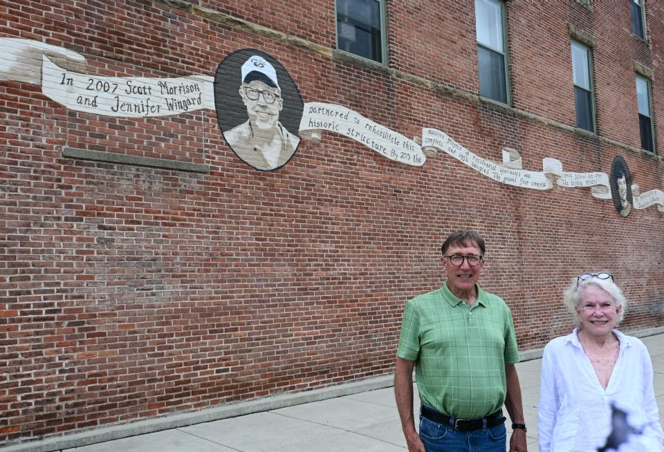 Architect Scott Morrison and developer Jennifer Wingard stand in front of the mural on the Hanchett Street side of the Kerr Building celebrating its completion.