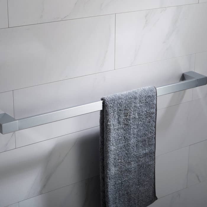 Towel hanging on a sleek bathroom rail, suitable for modern home decor