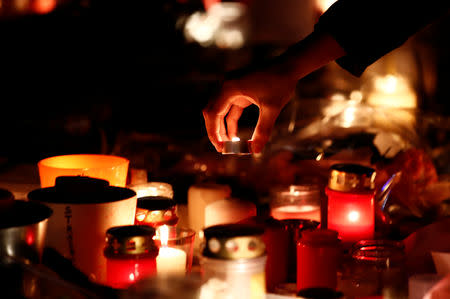 People light candles in tribute to the victims of the deadly shooting in Strasbourg, France, December 13, 2018. REUTERS/Christian Hartmann