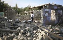 A view of an apartment building that was allegedly damaged by recent shelling during fighting over the breakaway region of Nagorno-Karabakh in Tartar region, Azerbaijan, Wednesday, Sept. 30, 2020. Leaders of Azerbaijan and Armenia brushed off the suggestion of peace talks Tuesday, accusing each other of obstructing negotiations over the separatist territory of Nagorno-Karabakh, with dozens killed and injured in three days of heavy fighting. (AP Photo/Aziz Karimov)