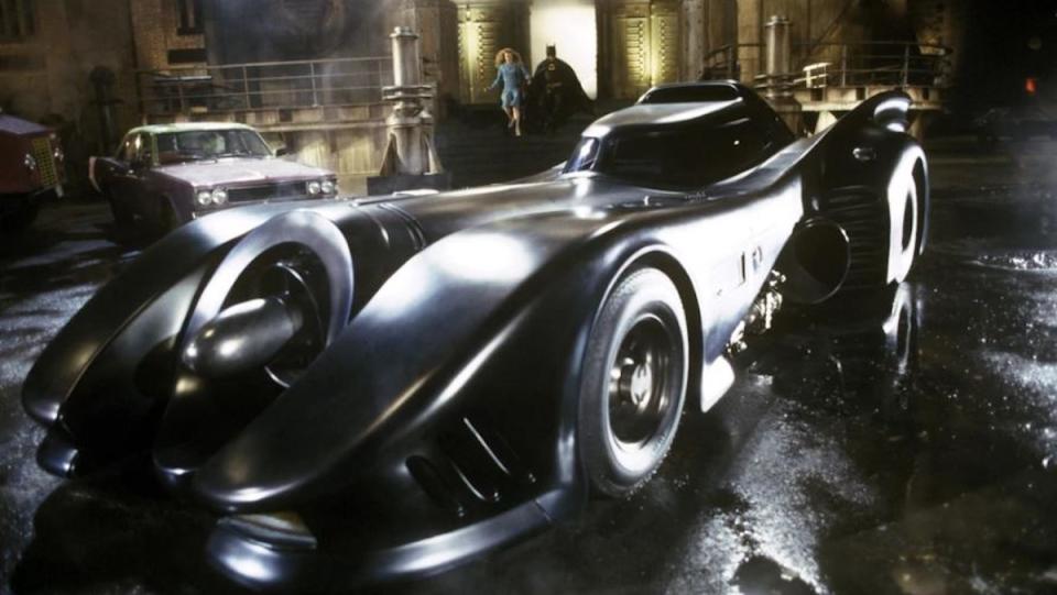 Bruce Wayne and Vicki Vale run to the Batmobile from Tim Burton's 1989 film a.k.a the 1989 Batmobile