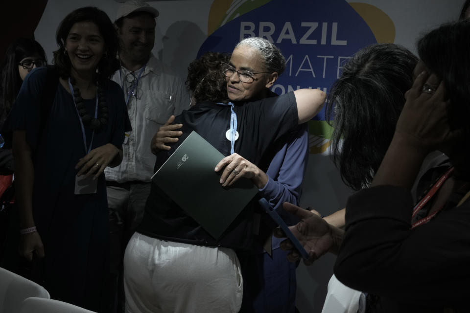Brazil's Marina Silva, a former environmental minister, embraces people at the Brazil Pavilion at the COP27 U.N. Climate Summit, Saturday, Nov. 12, 2022, in Sharm el-Sheikh, Egypt. (AP Photo/Nariman El-Mofty)