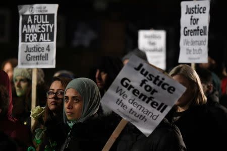 People take part in a silent candlelit march to mark the six month anniversary of the Grenfell Tower fire in London, Britain, December 14, 2017. REUTERS/Clodagh Kilcoyne/Files