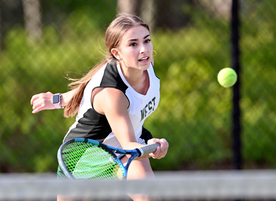 Sturgis West No. 2 singles player Pricillia Lanca charges the net for a shot at her East opponent on Tuesday, May 23, 2023.