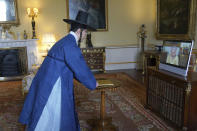 Queen Elizabeth II appears on a screen via videolink from Windsor Castle, where she is in residence, during a virtual audience to receive the Ambassador from the Republic of Korea, Gunn Kim at Buckingham Palace, London, Tuesday, Oct. 26, 2021. (Victoria Jones/Pool via AP)