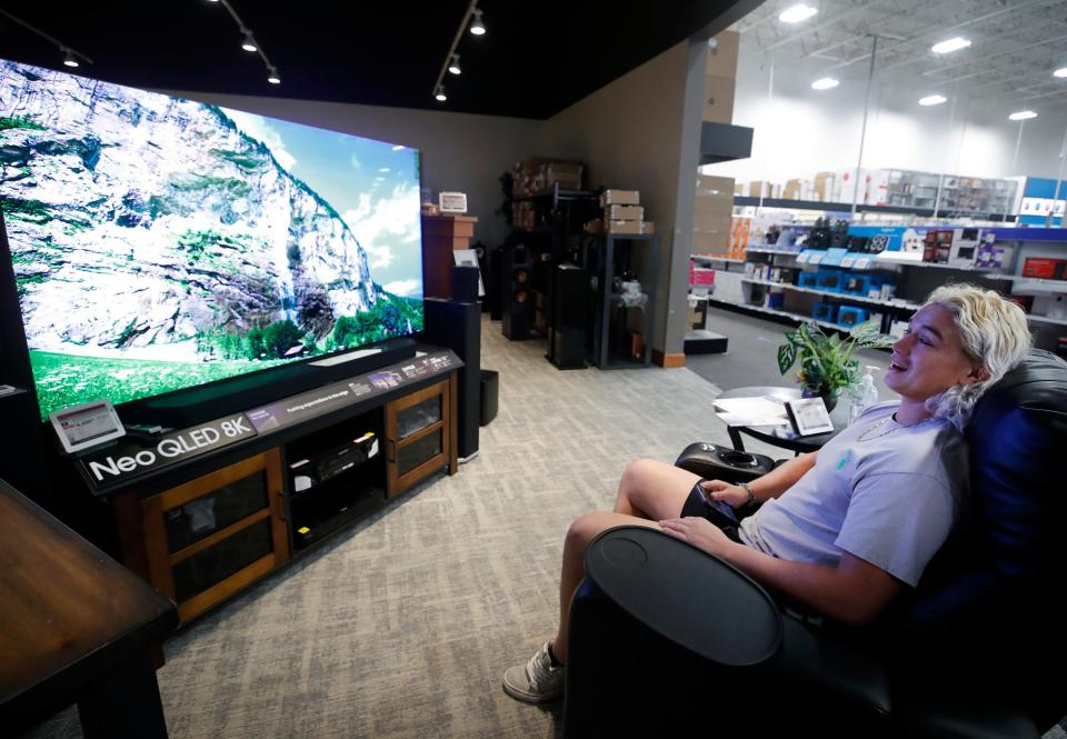 Marcelo Gonzalez takes a break from Black Friday shopping to check the picture quality on a high-def television at Best Buy in Daytona Beach. Although lines were shorter at some stores, many shoppers still embraced the traditional pre-dawn Black Friday ritual.
