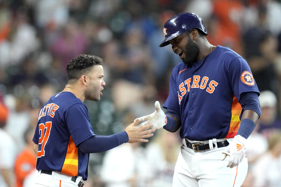 Houston Astros' Yordan Alvarez, right, celebrates with Jose Altuve after hitting a home run against the Seattle Mariners during the second inning of a baseball game Sunday, Aug. 22, 2021, in Houston. (AP Photo/David J. Phillip)