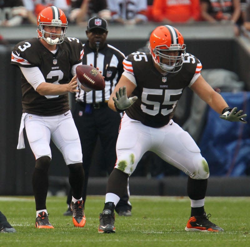 Cleveland quarterback Brandon Weeden (left) takes a snap from center Alex Mack during the Browns 31-17 loss to the Detroit Lions in their game at FirstEnergy Stadium on Oct. 13, 2013 in Cleveland. (Ed Suba Jr./Akron Beacon Journal)
