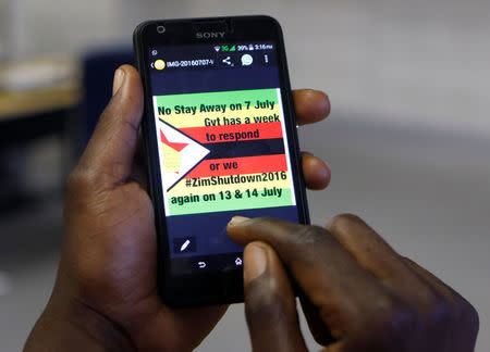 A man checks a message on his mobile phone, in Harare, Zimbabwe, July 7, 2016. REUTERS/Philimon Bulawayo