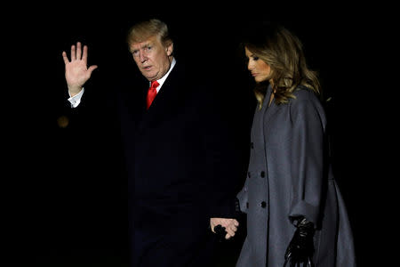 U.S. President Donald Trump waves as he and First Lady Melania Trump walk on South Lawn of the White House upon their return to Washington, U.S., from France, November 11, 2018. REUTERS/Yuri Gripas