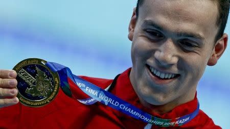 James Guy of Britain displays his gold medal after winning the men's 200m freestyle final at the Aquatics World Championships in Kazan, Russia August 4, 2015. REUTERS/Stefan Wermuth