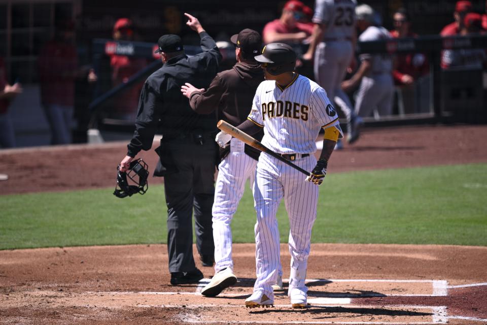 Padres designated hitter Manny Machado is ejected by home plate umpire Ron Kulpa while San Diego manager Bob Melvin argues in vain during Tuesday's game against the Diamondbacks.