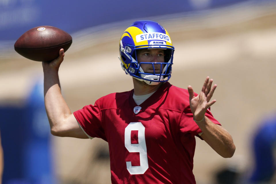 FILE - In this June 4, 2021, file photo, Los Angeles Rams quarterback Matthew Stafford passes during an NFL football practice in Thousand Oaks, Calif. With trips to the Super Bowl still in their recent memories, the Rams and the San Francisco 49ers made the decision this offseason that they needed more dynamic quarterback play to remain contenders in the long run. That led both NFC West rivals to make aggressive moves, trading multiple first-round picks to bring Stafford to Los Angeles and rookie Trey Lance to San Francisco. (AP Photo/Mark J. Terrill, File)