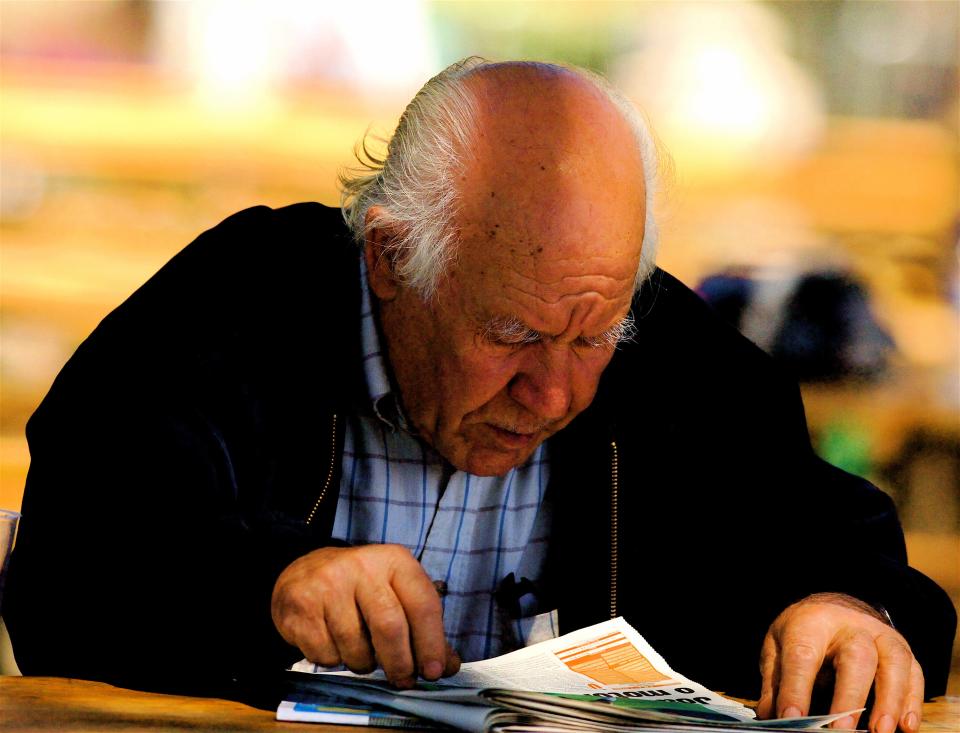 grandfather old person reading a newspaper