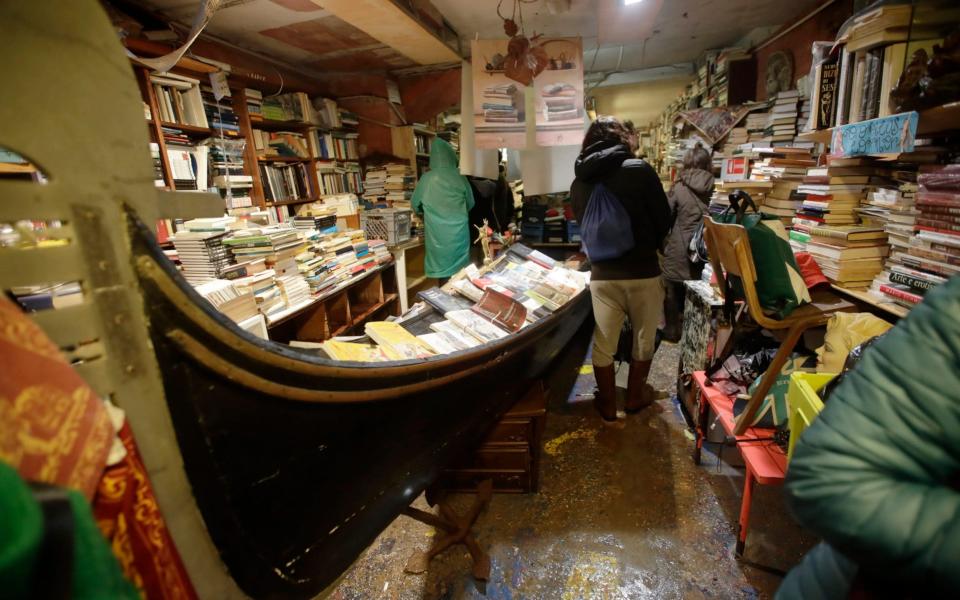 The bookshop Acqua Alta was hit by flooding, with hundreds of books turned to soggy pulp - Luca Bruno/AP