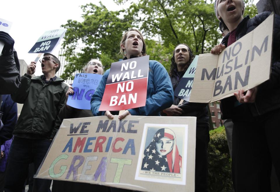 Protesters are pictured demonstrating against Mr Trump's travel ban: AFP/Getty Images