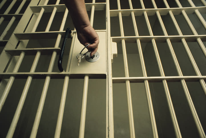 A guard locking a prison cell