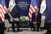 US President Donald Trump, right, attends a meeting with his Iraqi counterpart Barham Salih at the World Economic Forum in Davos, Switzerland, Wednesday, Jan. 22, 2020. Trump's two-day stay in Davos is a test of his ability to balance anger over being impeached with a desire to project leadership on the world stage. (AP Photo/Evan Vucci)