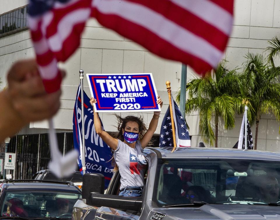 In this Oct. 10, 2020, a caravan in favor of President Trump drives down the Little Havana neighborhood of Miami. Florida's Cuban American voters remain a bright spot in Trump's effort to retain his winning coalition from 2016. Polls show his strong support from these key voters may even be growing to include the younger Cuban Americans that Democrats once considered their best hope of breaking the GOP's hold. (Pedro Portal/Miami Herald via AP)