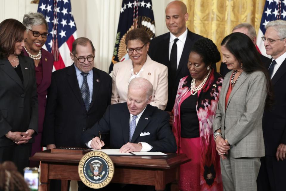 Flanked by U.S. Vice President Kamala Harris, lawmakers and cabinet members, U.S. President Joe Biden signs an executive order enacting further police reform in the East Room of the White House on May 25, 2022 in Washington, DC. (Photo by Anna Moneymaker/Getty Images)