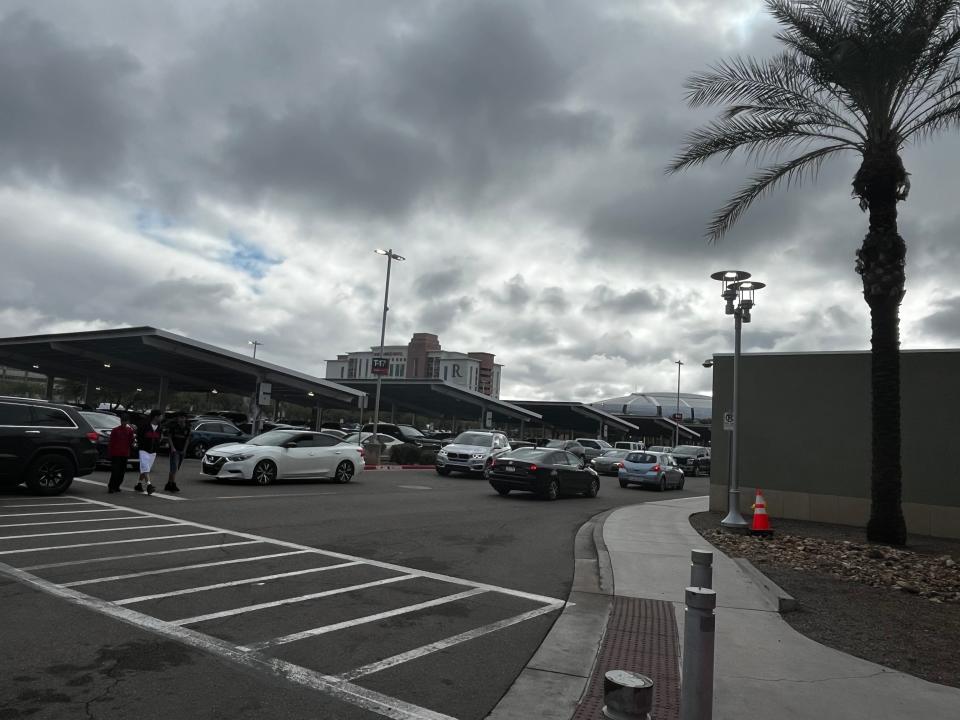 Shoppers look for parking near Tanger Outlets in Glendale on Dec. 23, 2023.