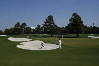 Jordan Spieth hits out of a bunker on the driving range during a practice round for the Masters golf tournament on Wednesday, April 7, 2021, in Augusta, Ga. (AP Photo/Charlie Riedel)