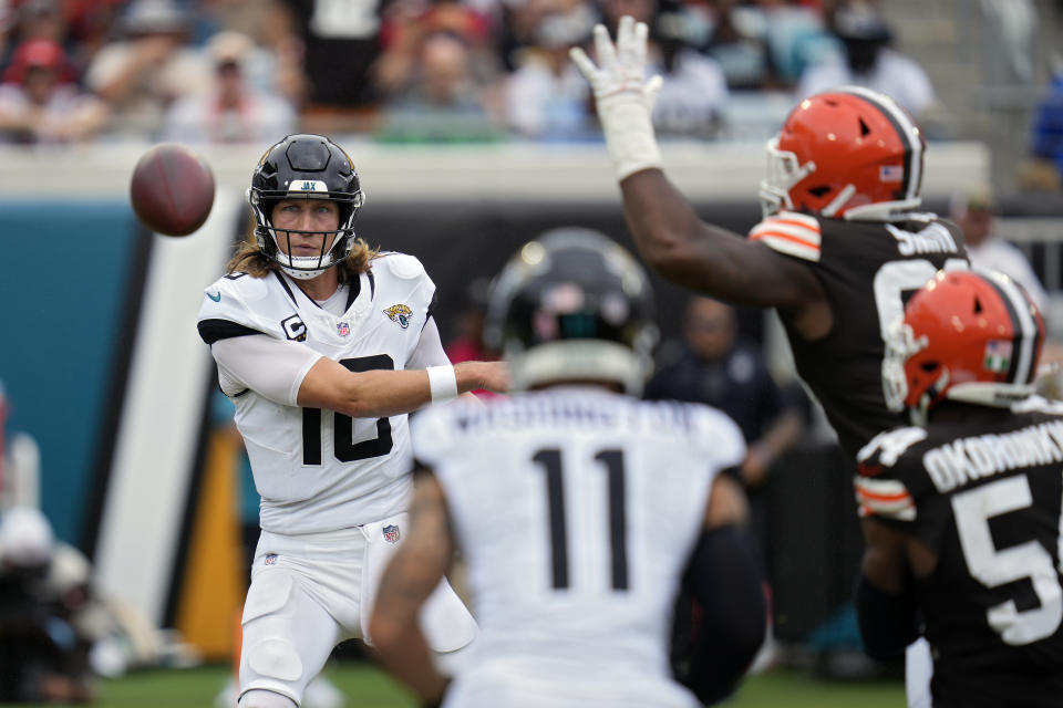 Jacksonville Jaguars quarterback Trevor Lawrence (16) throws a pass to wide receiver Parker Washington (11) as he is pressured by the Cleveland Browns defense during the second half of an NFL football game Sunday, Sept. 15, 2024, in Jacksonville, Fla. (AP Photo/John Raoux)