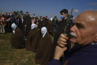 Penitents take part in 'Los Picaos' procession during Holy Week in San Vicente de La Sonsierra, northern Spain, Friday, April 15, 2022. (AP Photo/Alvaro Barrientos)