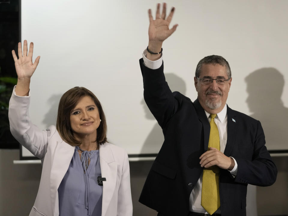 Presidential candidate Bernardo Arevalo and his running mate Karin Herrera wave during a press conference after preliminary results showed them as the victors in a presidential run-off election in Guatemala City, Sunday, Aug. 20, 2023. (AP Photo/Moises Castillo)