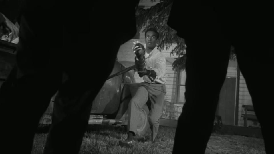 A survivor fends off zombies in Night of the Living Dead