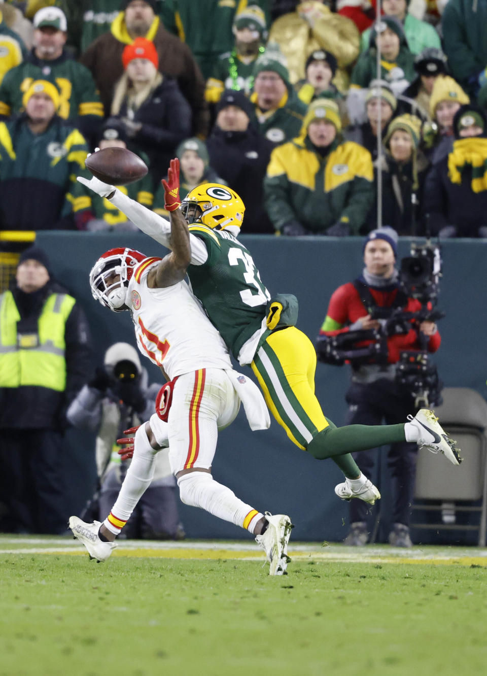 FILE - Green Bay Packers' Carrington Valentine, right breaks up a pass to Kansas City Chiefs' Marquez Valdes-Scantling during an NFL football game Sunday, Dec. 3, 2023, in Green Bay, Wis. The Packers beat the Chiefs 27-19. (AP Photo/Jeffrey Phelps, File)