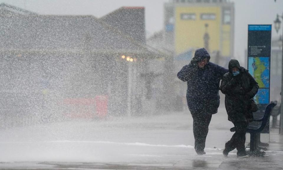 people in raincoats in rain and spray