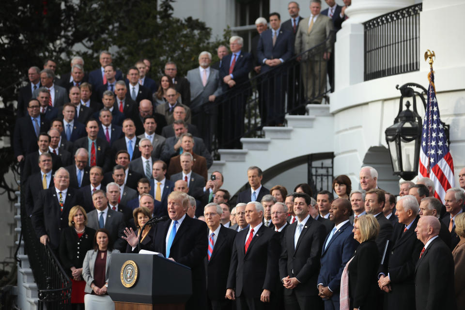 WASHINGTON, DC - DECEMBER 20:  U.S. President Donald Trump, flanked by Republican lawmakers, celebrates Congress passing the Tax Cuts and Jobs Act on the South Lawn of the White House on December 20, 2017 in Washington, DC. The tax bill is the first major legislative victory for the GOP-controlled Congress and Trump since he took office almost one year ago.  (Photo by Chip Somodevilla/Getty Images)