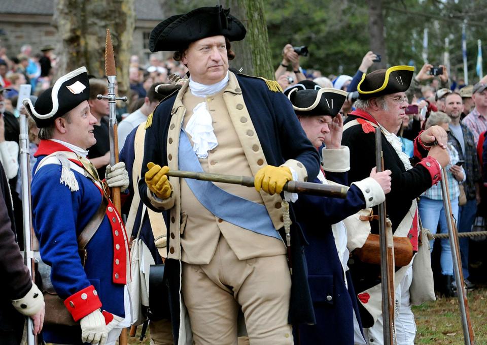 John Godzieba, portraying General George Washington, with his Army behind him, looks across the Delaware River before crossing in the annual re-enactment on Christmas Day, Friday, Dec. 25, 2015.