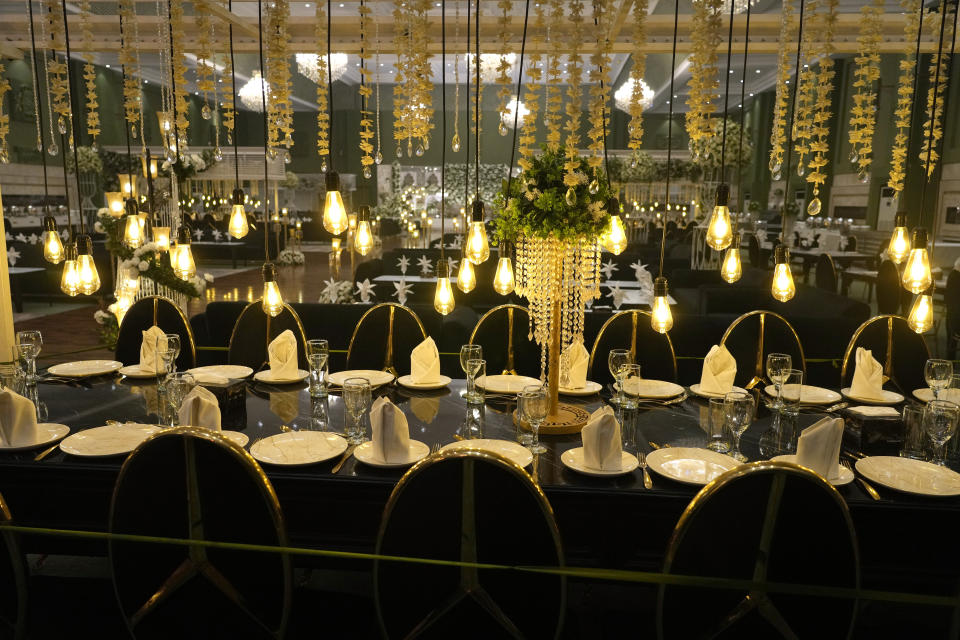 A decorated table is ready for a wedding ceremony in the Manor marquee at a wedding halls compound, in Islamabad, Pakistan, Saturday, Jan. 20, 2024. Businessmen in the capital Islamabad have taken the idea of convenience and developed a wedding compound that sits next to a six-lane highway. There are a dozen venues in this location, some are marriage multiplexes offering more than one hall. (AP Photo/Anjum Naveed)