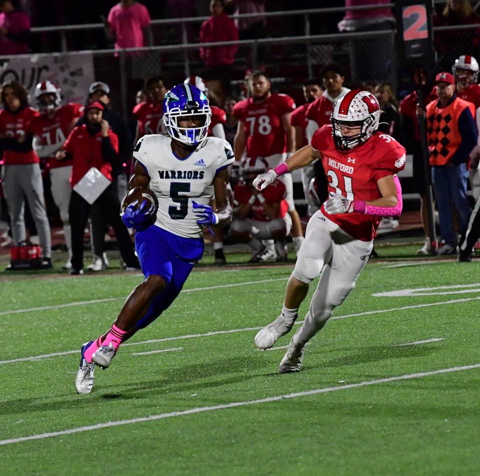 Tra'mar Harris (5) of Winton Woods gets a reception and runs for a Warriors' first down against Milford Oct. 7. The Warriors are defending Division II champions and enter the postseason 10-0.