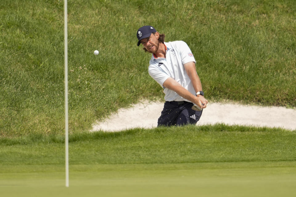 Tommy Fleetwood, of Britain, chips out of a bunker to the 11th green during the second round of the men's golf event at the 2024 Summer Olympics, Friday, Aug. 2, 2024, at Le Golf National in Saint-Quentin-en-Yvelines, France. (AP Photo/George Walker IV)