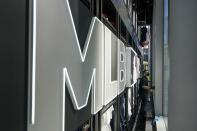 A worker cleans the a window display at the MLB Flagship store Wednesday, Sept. 30, 2020, in New York. Major League Baseball joins the NBA and NHL in operating stores in Manhattan when baseball’s first retail store opens Friday across from Radio City Music Hall. (AP Photo/Frank Franklin II)