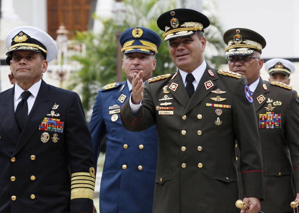 FILE - In this Aug. 8, 2017 file photo, Venezuela's Defense Minister Vladimir Padrino Lopez, center right, accompanied by a group of military commanders, arrives at the National Assembly building, in Caracas, Venezuela. The Trump administration slapped financial sanctions on Tuesday, Sept. 25, 2018, on four members of Maduro’s inner circle, including his wife, the nation’s vice president and Padrino Lopez, on allegations of corruption. (AP Photo/Ariana Cubillos, File)